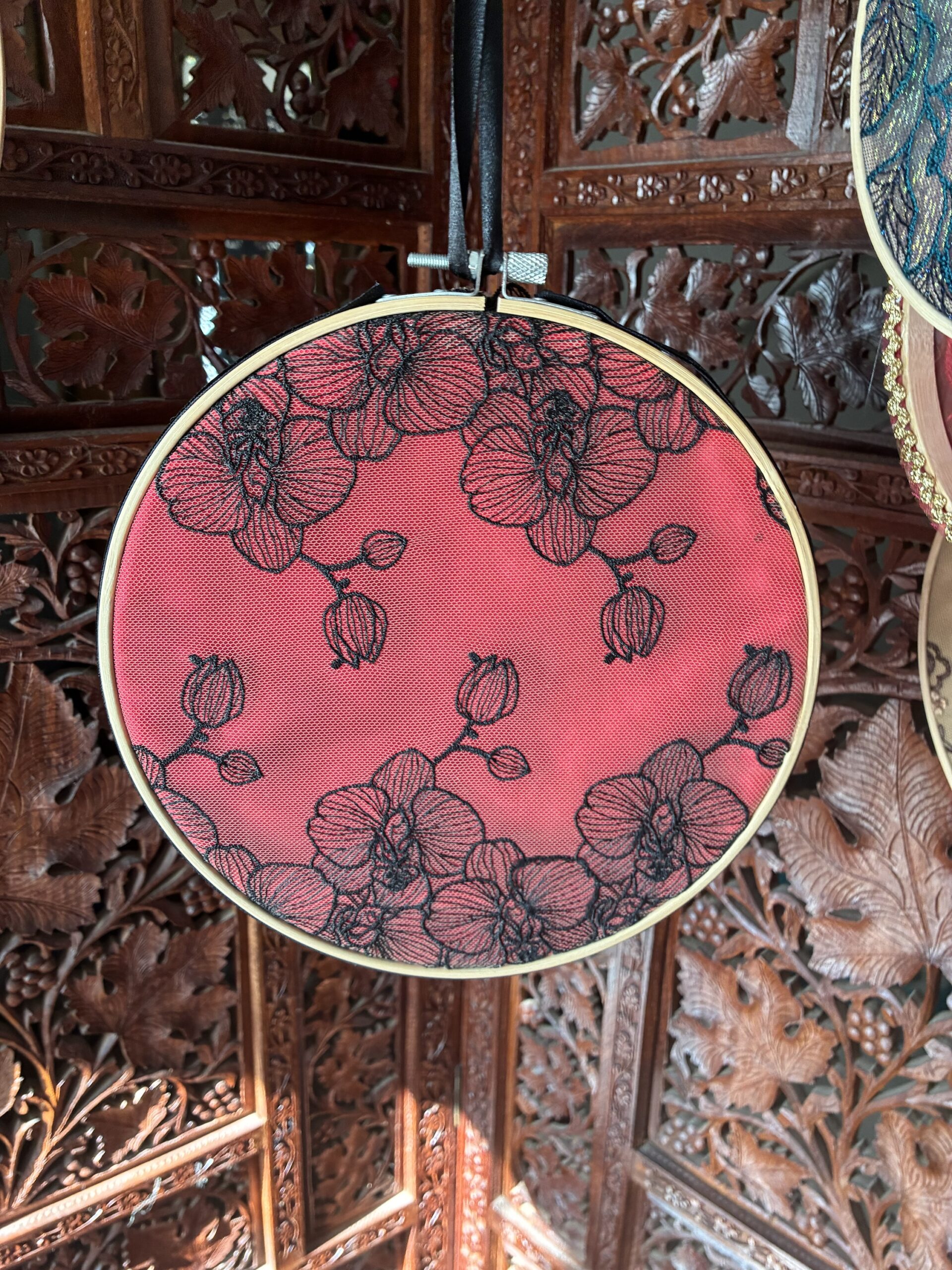 Black orchid lace over red silk in 10” hoop